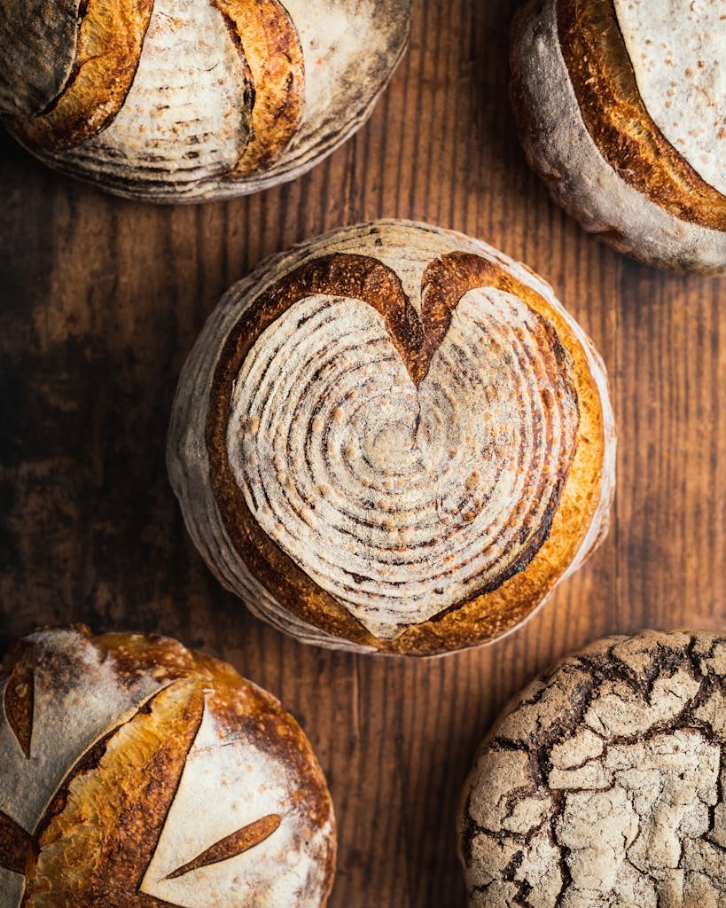 Assorted Artisan Bread Loaves on Wooden Table