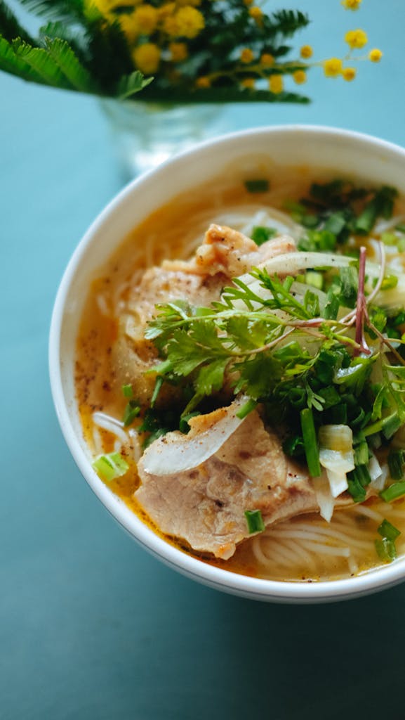 Authentic Vietnamese pho with pork, cilantro, and fresh herbs in Saverne.