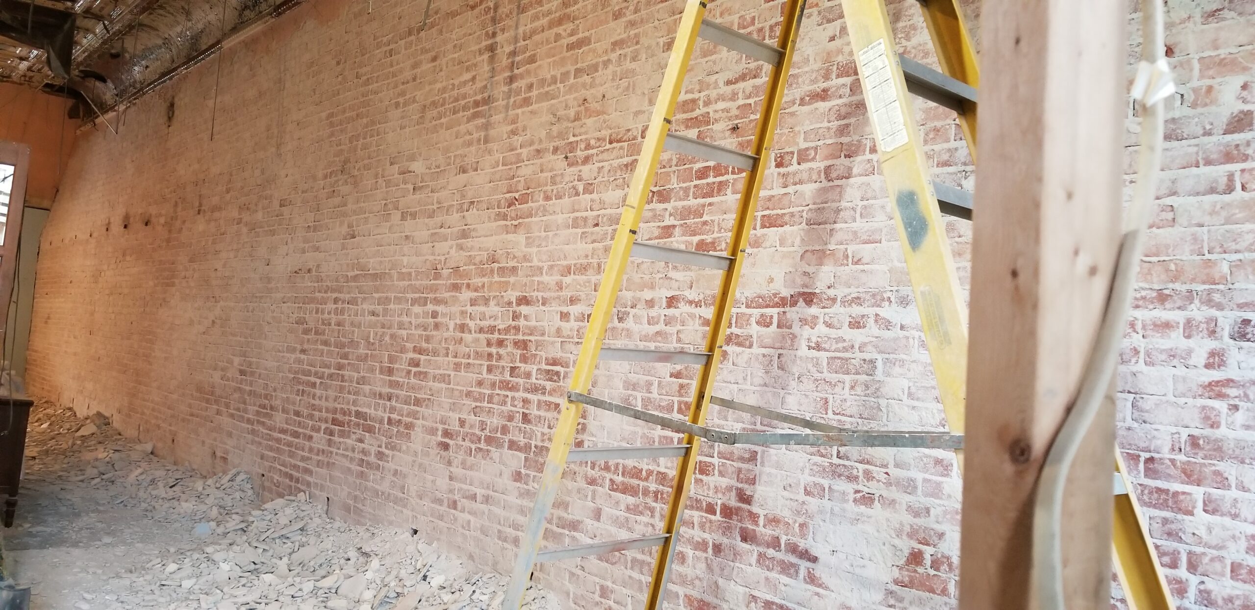 A large wall of freshly exposed brick on display