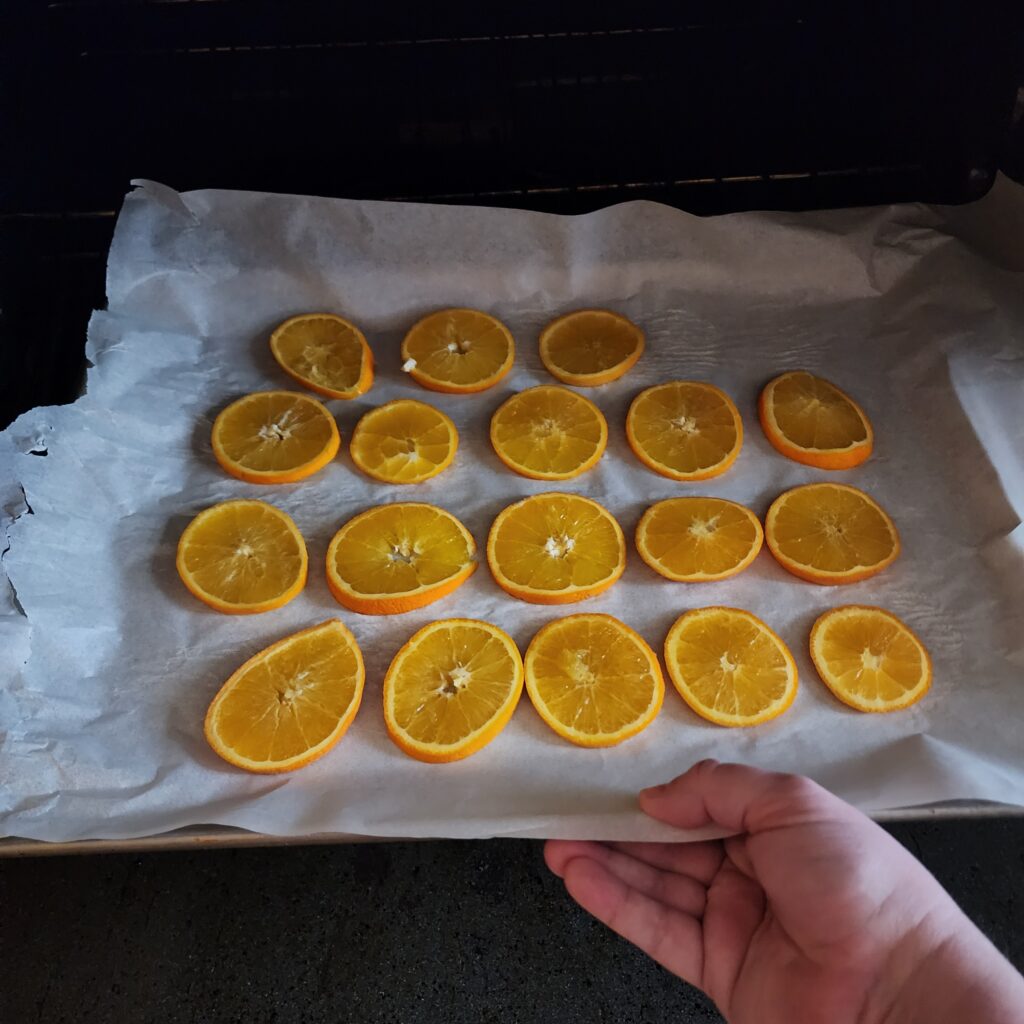 Orange slices  on a cookie sheet in the oven