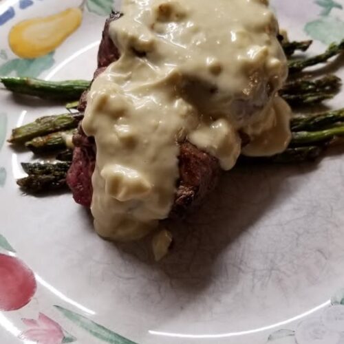 Blue cheese sauce is paired beautifully with a filet and grilled asparagus