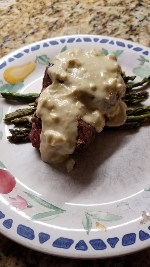 Blue cheese sauce is paired beautifully with a filet and grilled asparagus