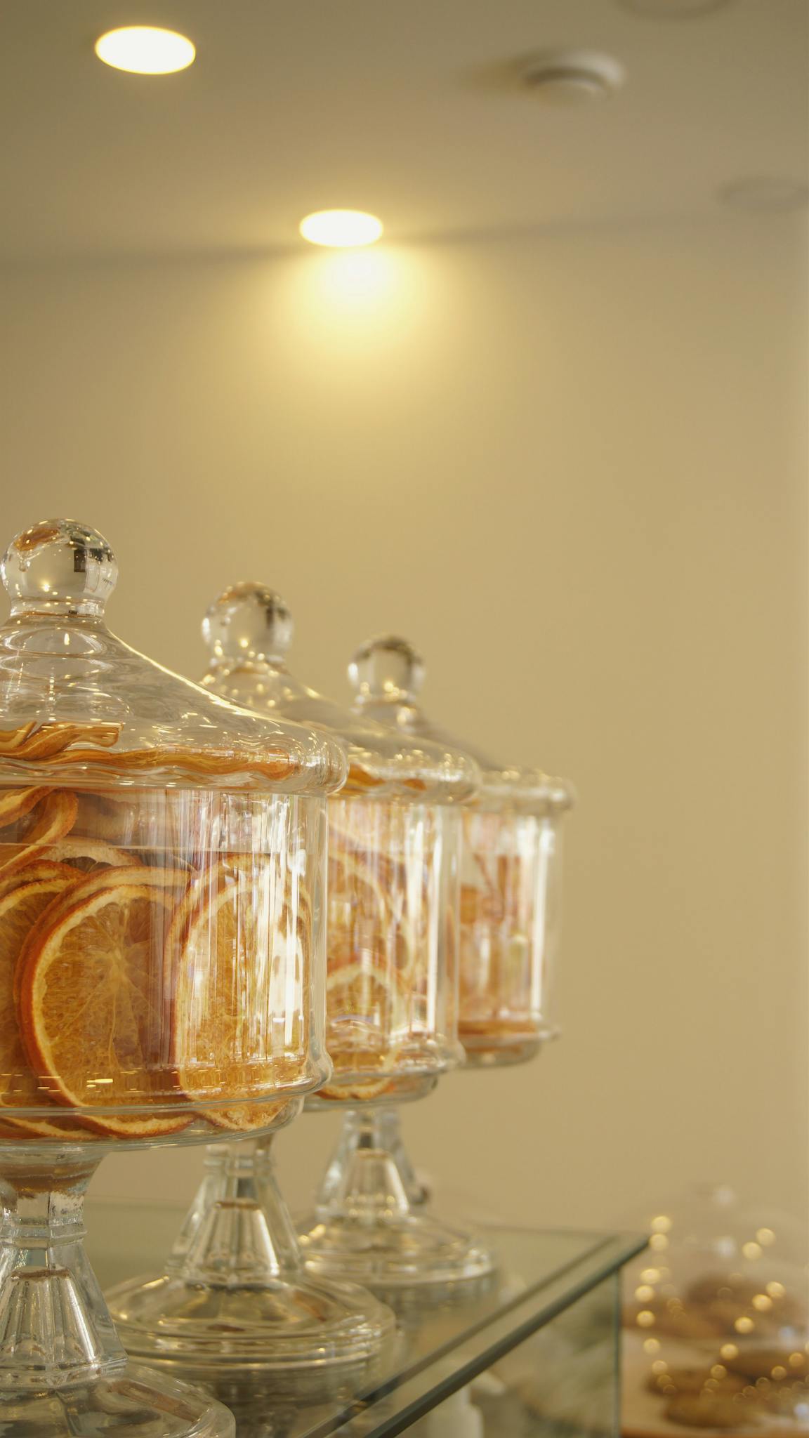 Stylish arrangement of dried orange slices in glass jars, perfect for home or cafe decor.