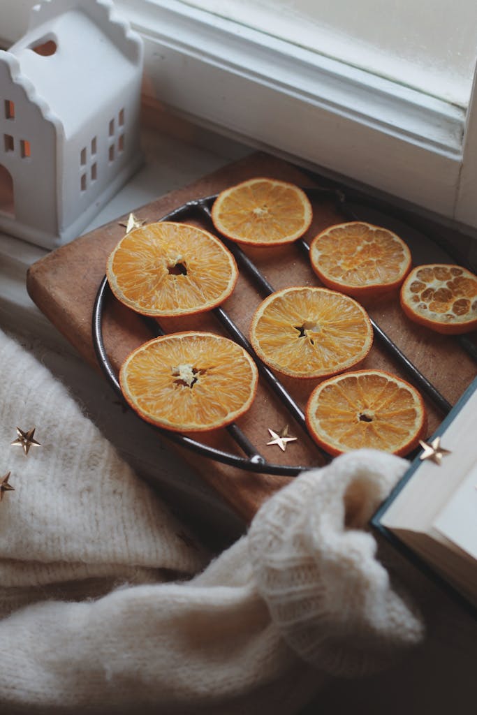 Warm and inviting autumn composition featuring dried orange slices by a window.