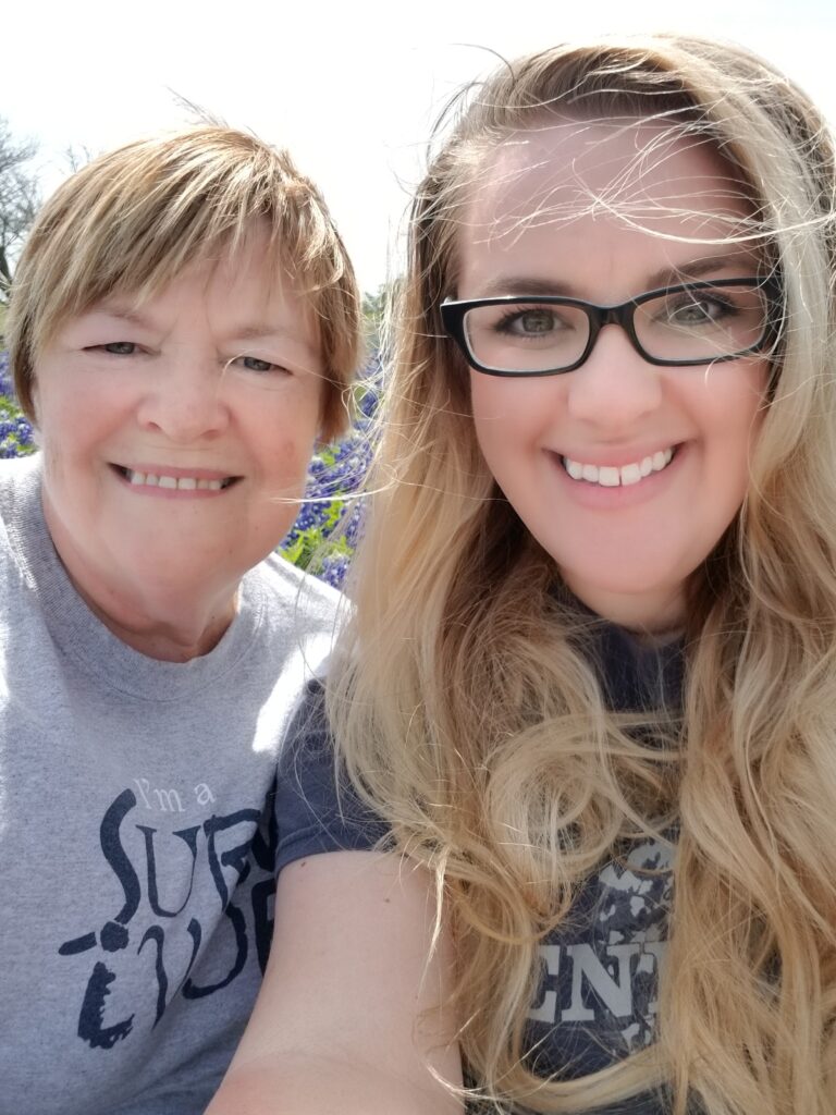 Mother and daughter standing together in a bluebonnet field