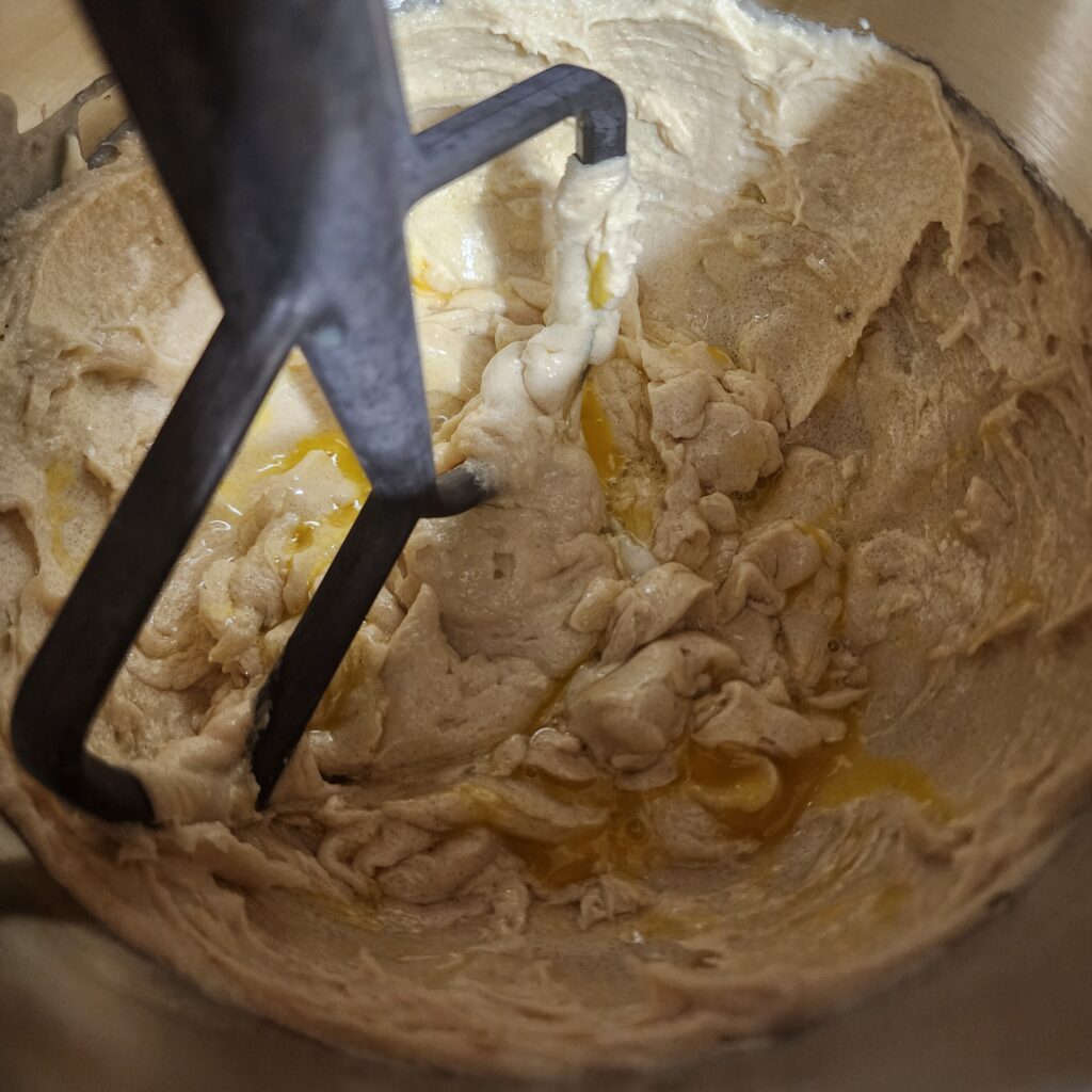 Chocolate Chip Cookie Recipe wet ingredients being mixed in a stand mixer