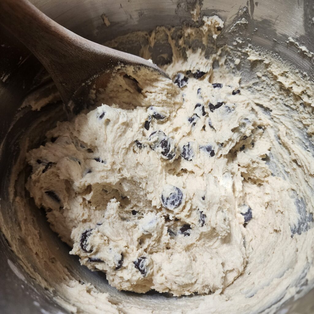 Chocolate chip cookie dough in a mixing bowl