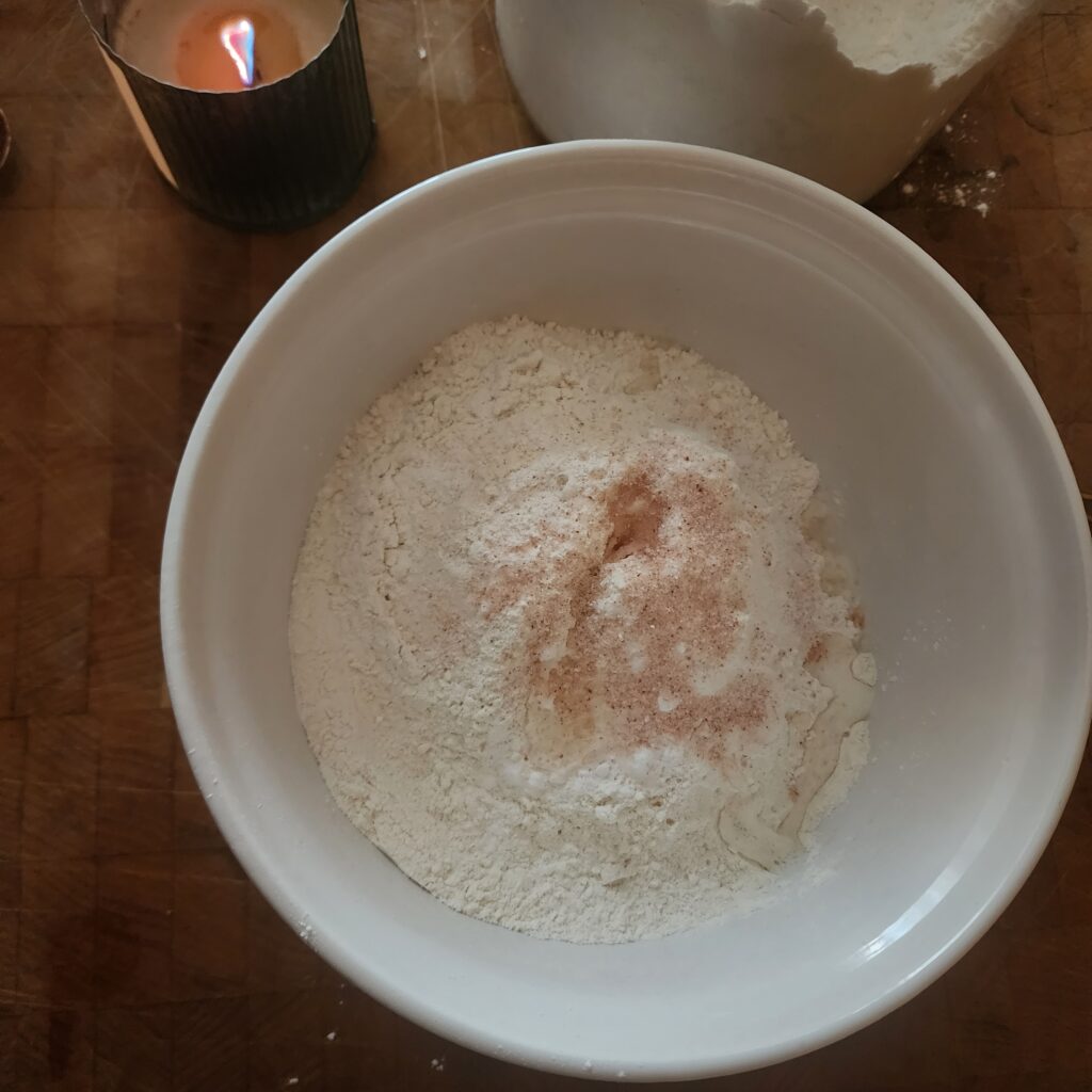 Dry ingredients for sourdough discard cinnamon rolls in a large bowl