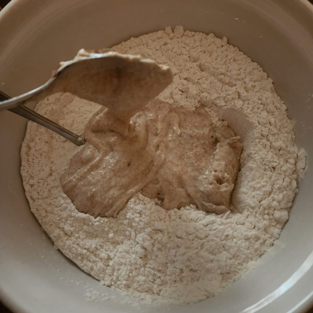 Sourdough Discard is being combined with dry ingredients to form a dough