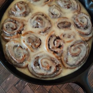 Sourdough Discard Cinnamon Rolls fresh from the oven in a cast iron skillet