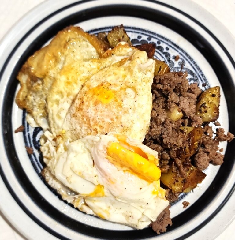 Rosemary Potatoes are layered with ground turkey sausage and topped with a fried egg