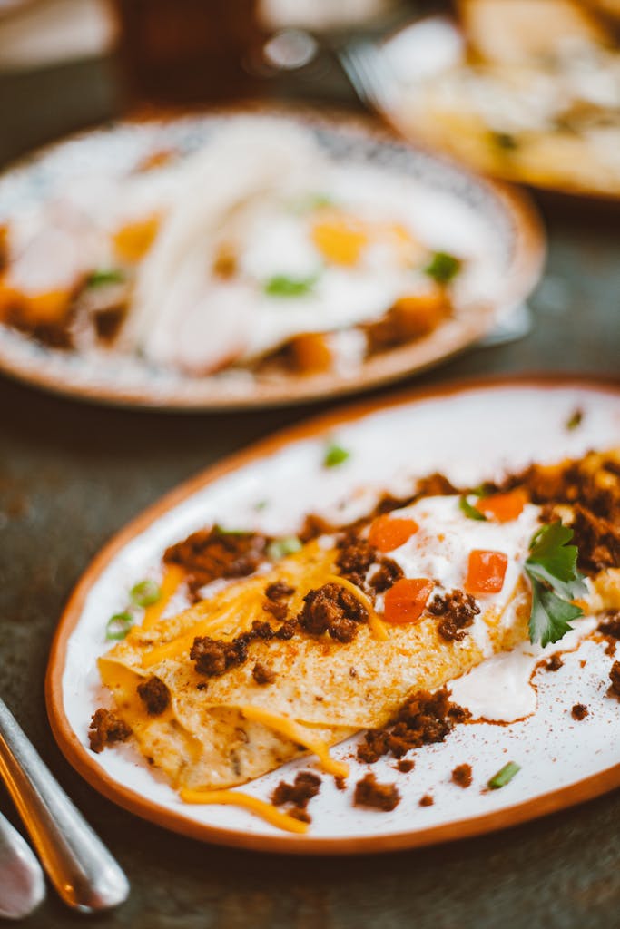 Delicious enchiladas topped with cheese and herbs on a rustic plate, ready to eat.