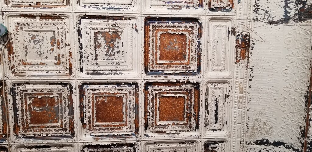 118 year old pressed tin ceiling with chipped paint