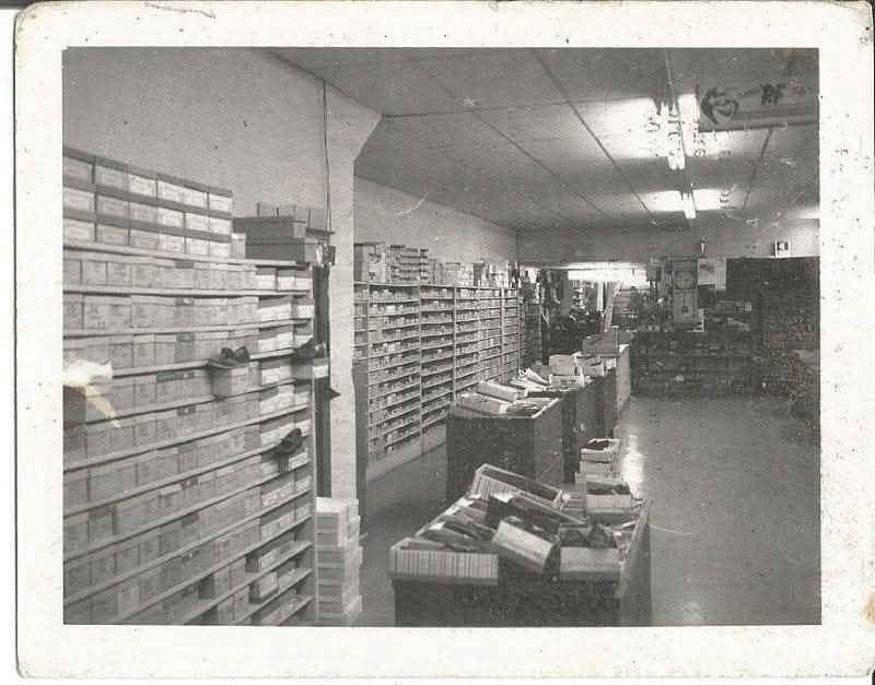 Black and white photo of an old shoe store 