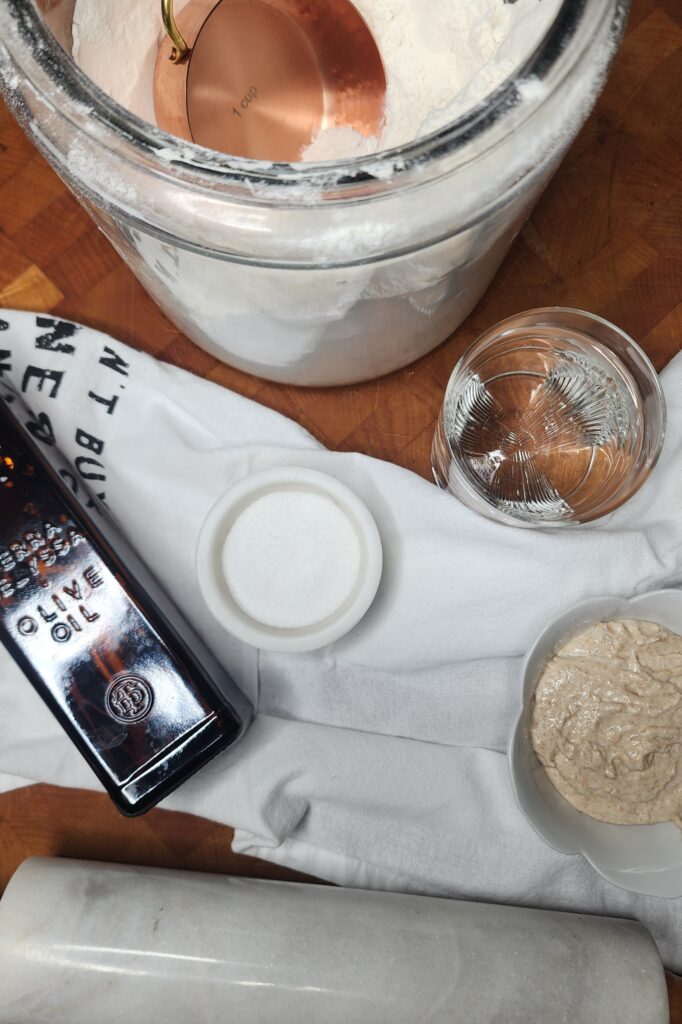 Olive oil, salt, sourdough discard, flour, and water  on butcher block