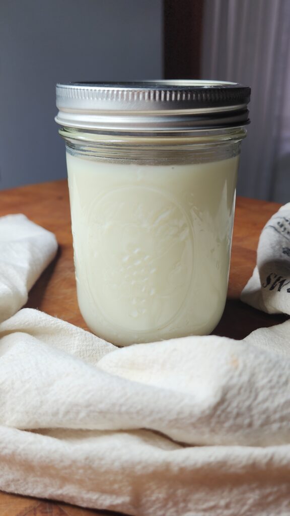 Fresh raw buttermilk in a mason jar