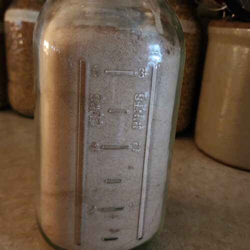 A half gallon mason jar on homemade brownie mix in bulk ready to bake delicious fudgy brownies for an easy dessert recipe.