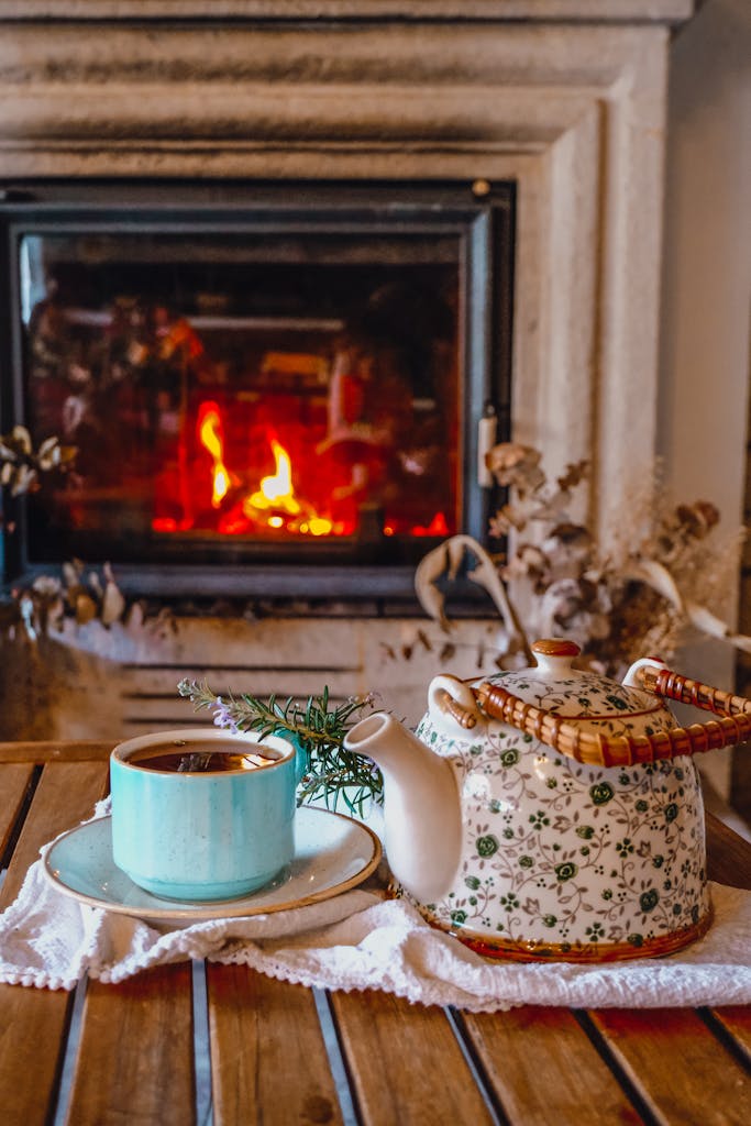 A relaxing scene with a tea set and warm fireplace, perfect for a cozy home atmosphere.