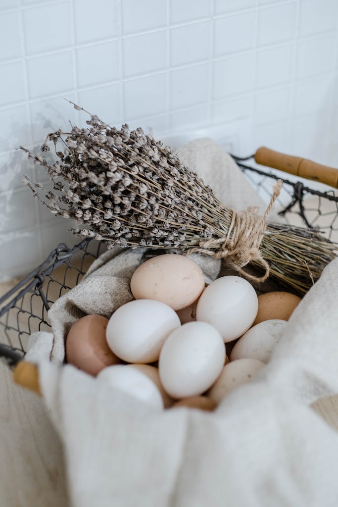 Basket with eggs and dried lavender on neutral background, exuding rustic charm.