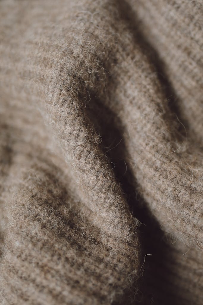 Detailed close-up of a cozy woolen textile showcasing its soft texture and pattern.