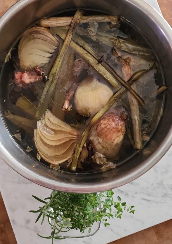 Freshly made bone broth is ready to be strained and stored in a jar for a gut-healthy beverage or savory soup base.