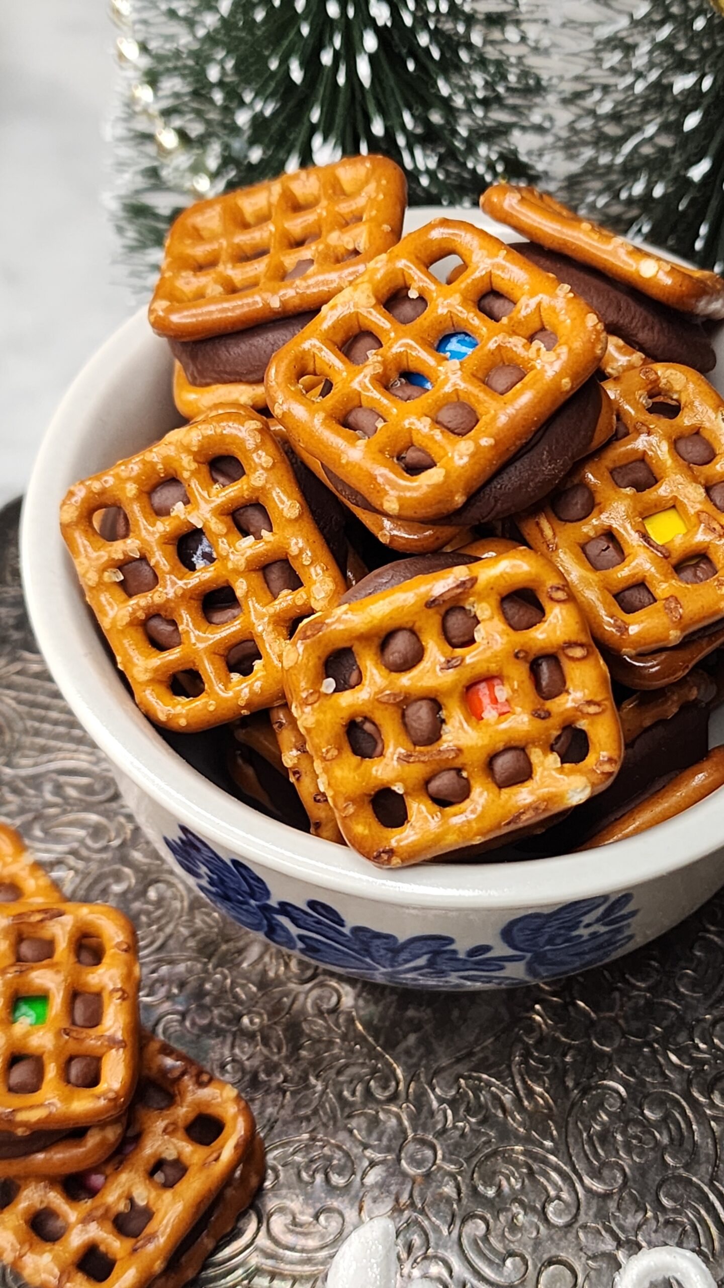 Festive Sweet and Salty Christmas candy in a mug with Christmas trees in the background