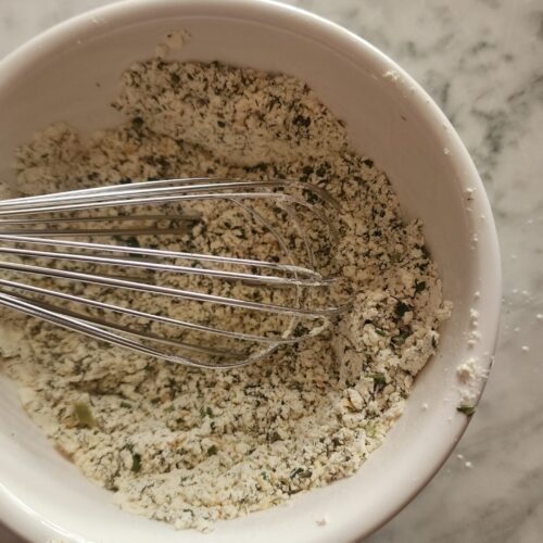 Homemade Ranch Seasoning Mix in a white bowl on a marble surface.