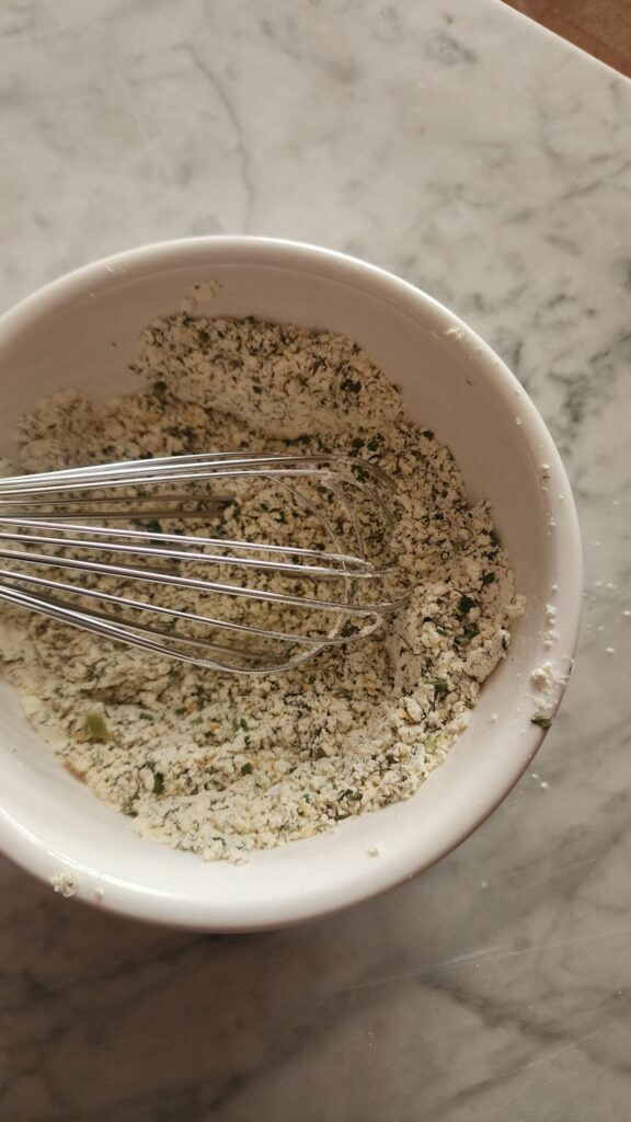 Homemade Ranch Seasoning Mix in a white bowl on a marble surface.