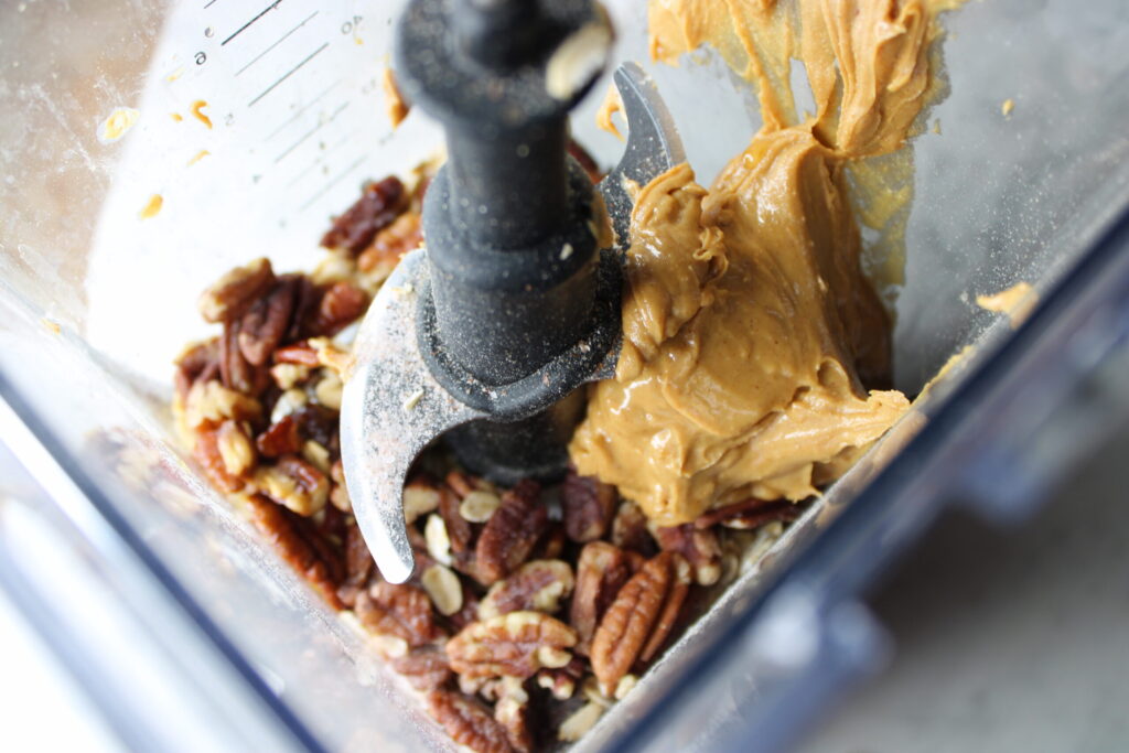 Ingredients for healthy pecan date bars in a blender ready to mix.