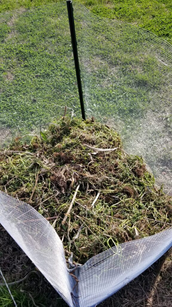 A homemade compost pile with yard waste. 