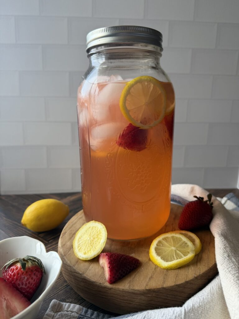 A jar of homemade strawberry lemonade water kefir ready to serve. 