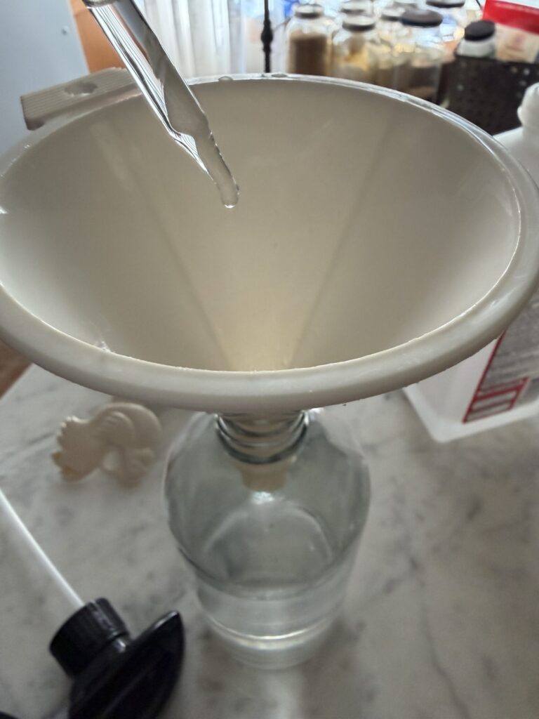 Adding essential oils to homemade glass cleaner to create a relaxing scent.