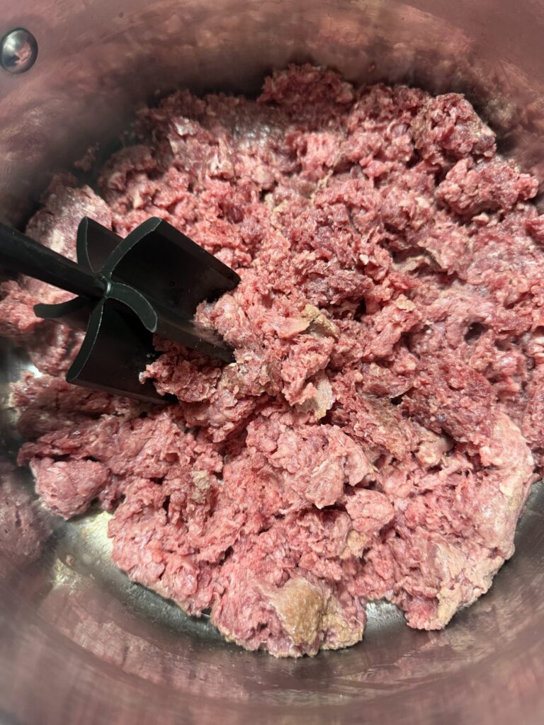 Ground beef cooking in a sauce pan. 