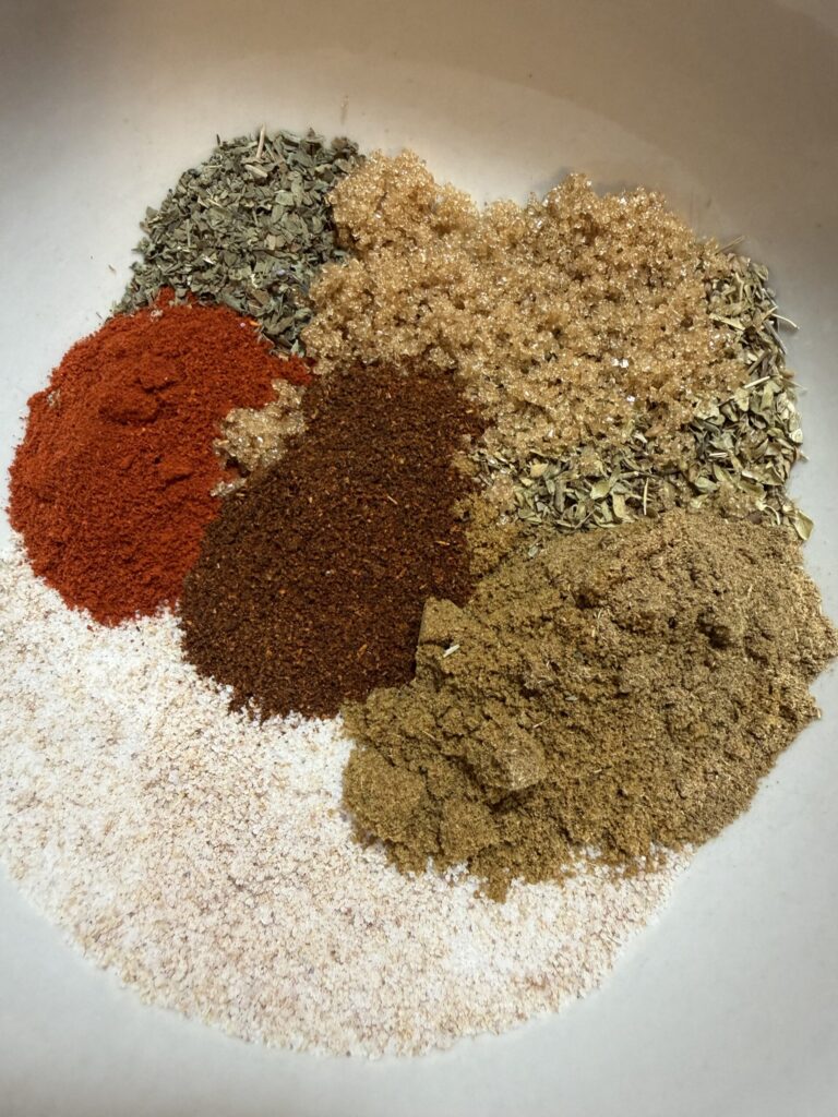 Spices for pork carnitas in a bowl.