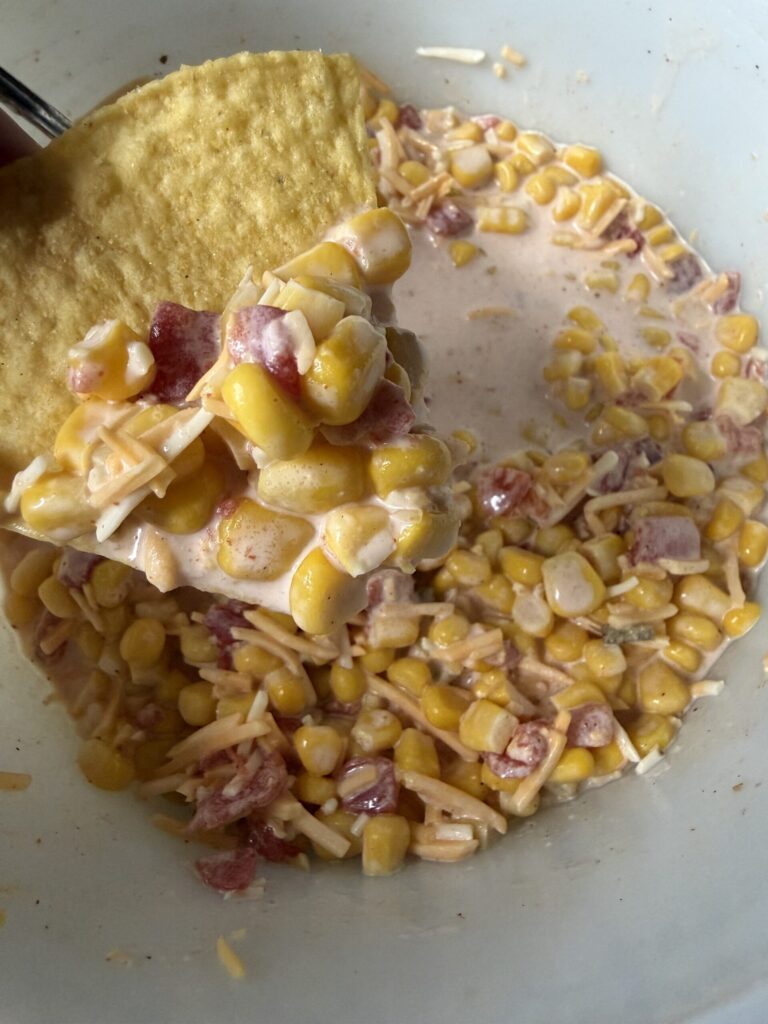 A chip with corn salsa dip for a perfect summertime snack. 
