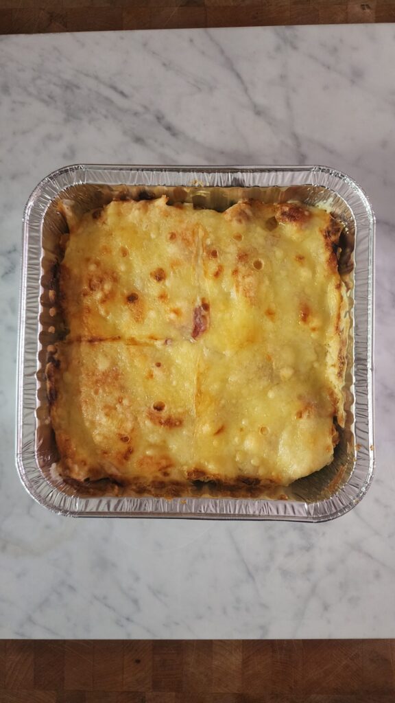 Fresh out of the oven chicken cordon bleu casserole on a marble surface.