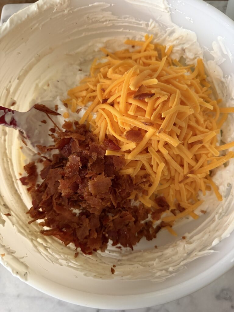 Cheddar and crispy bacon are added to a creamy base to make chicken bacon ranch dip.