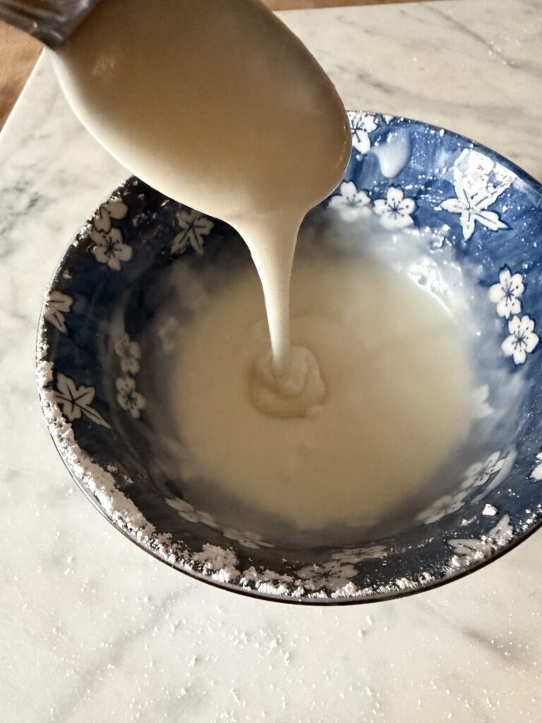 Powder sugar, melted butter, and lemon juice is combined to make a sweet lemon glaze.
