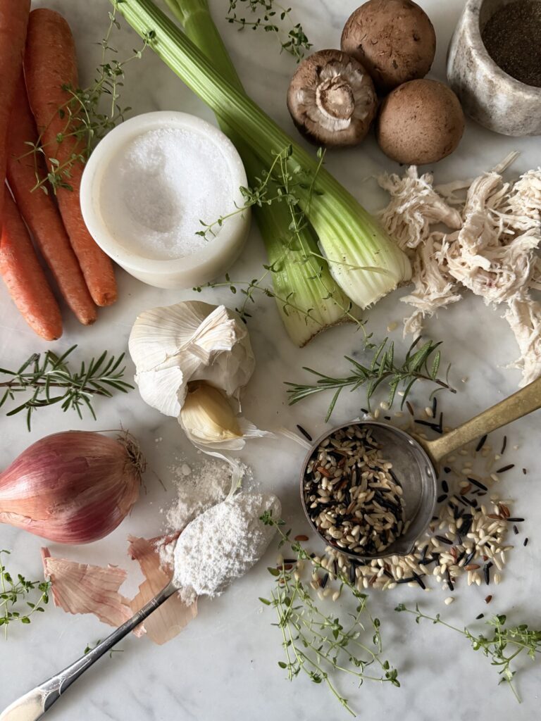 Chicken and wild rice soup ingredients on a marble surface
