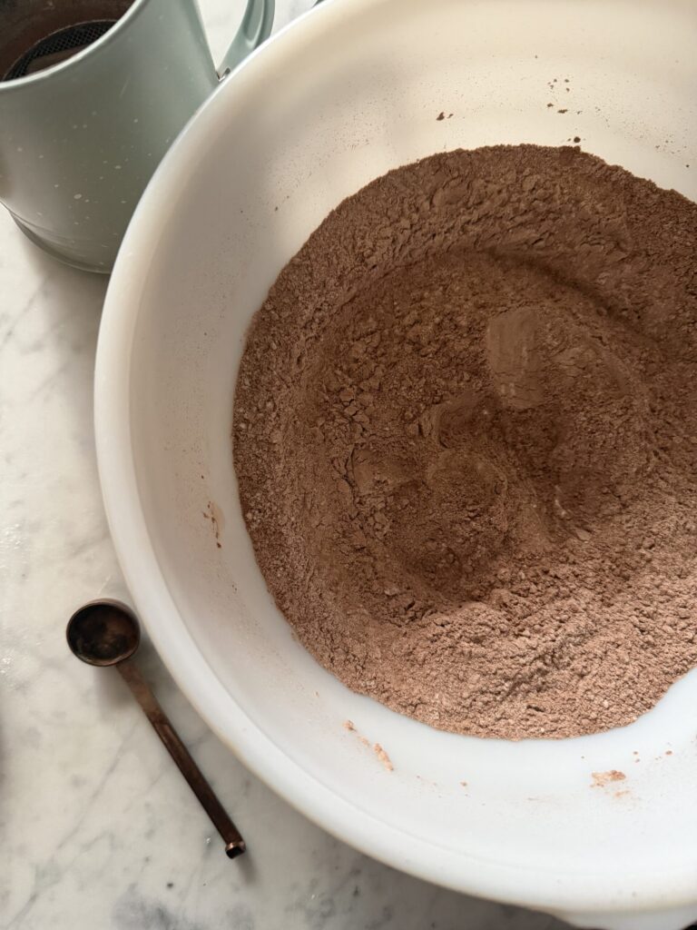 Dry mix to make pumpkin swirl brownies in a white bowl on a marble surface.
