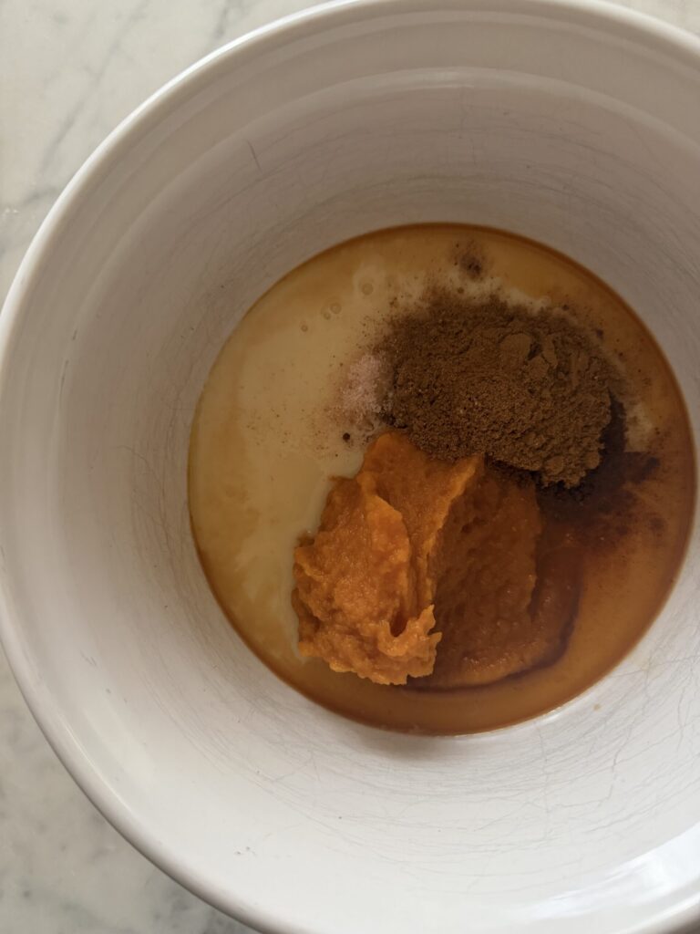 Sweetened Condensed milk, pumpkin puree, brown sugar, and vanilla are added in a bowl for Pumpkin Sauce