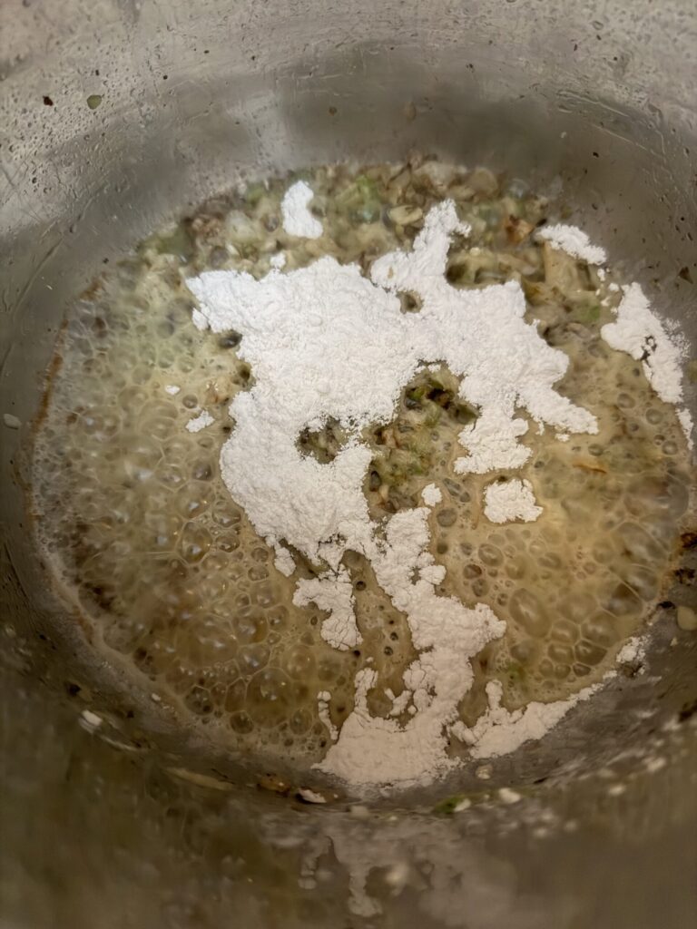 Flower is added to cooked onion and celery with melted butter