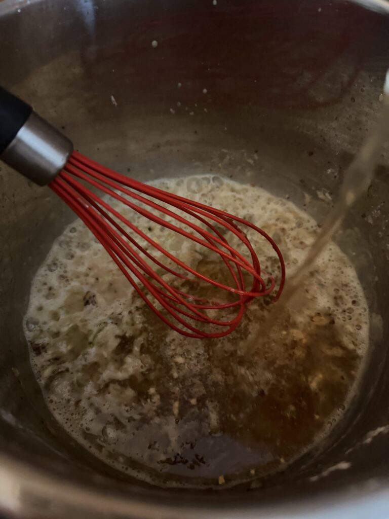 Homemade Chicken bone broth is added to flour and cooked veggies to make beer cheese soup
