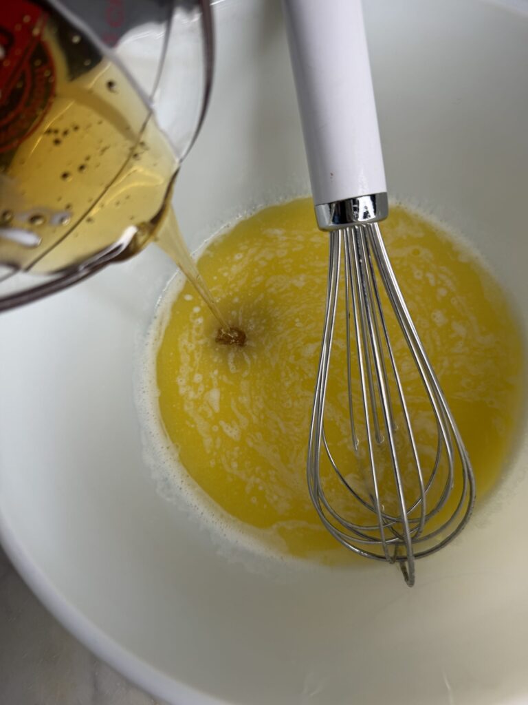 Honey is added to a bowl of sourdough cornbread ingredients