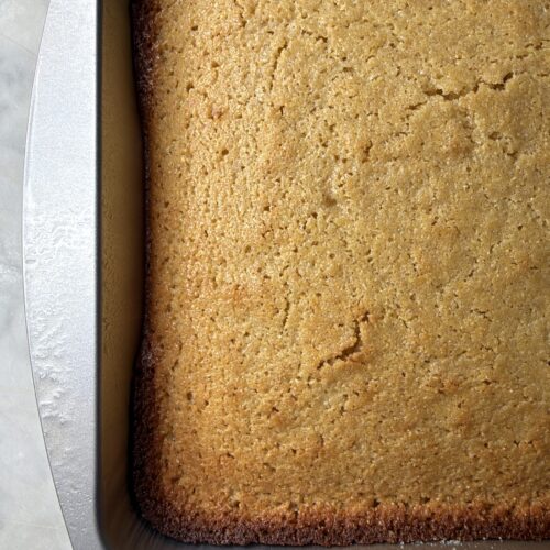 Golden freshly baked sourdough cornbread in a baking pan