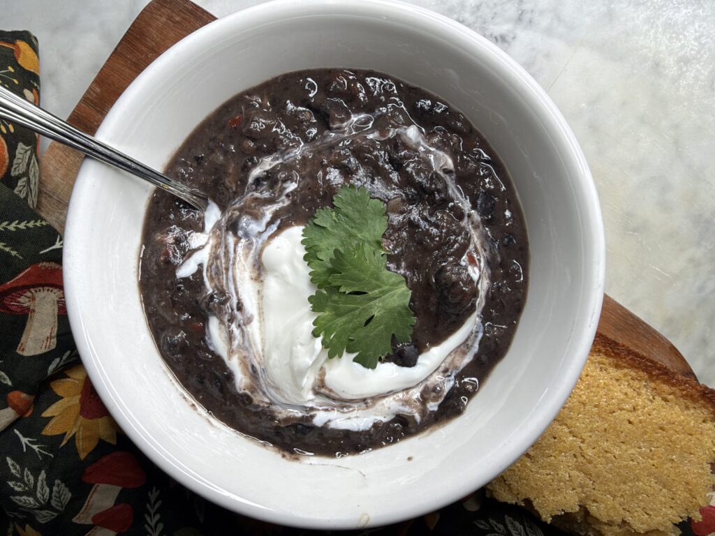 Cuban black bean soup with swirls of creamy yogurt and fresh cilantro